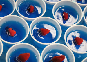 Blue Jell-O Cups with red fish gummies