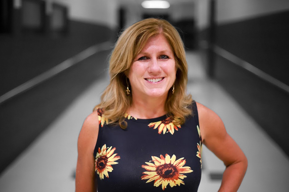 Dana Cull stands in hallway