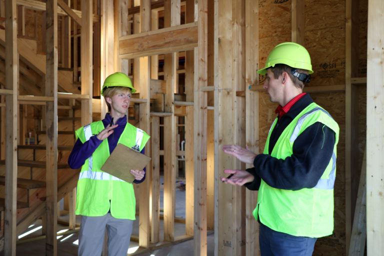 Engineer and Project Manager Travis Greenwell reviews framework with Eli Hill at a new build