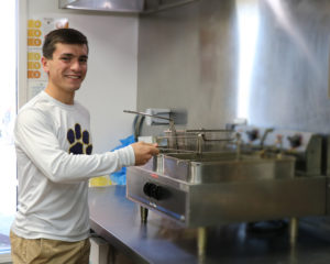 Omar operates the deep fryer