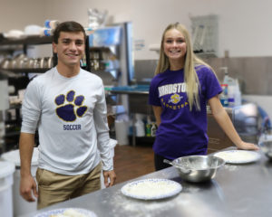 Omar and Kadence stand in the kitchen