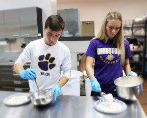 Omar and Kadence prepare food mixes