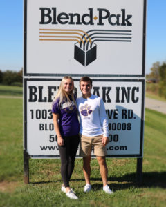 Omar and Kadence stand in front of the Blend Pak Sign