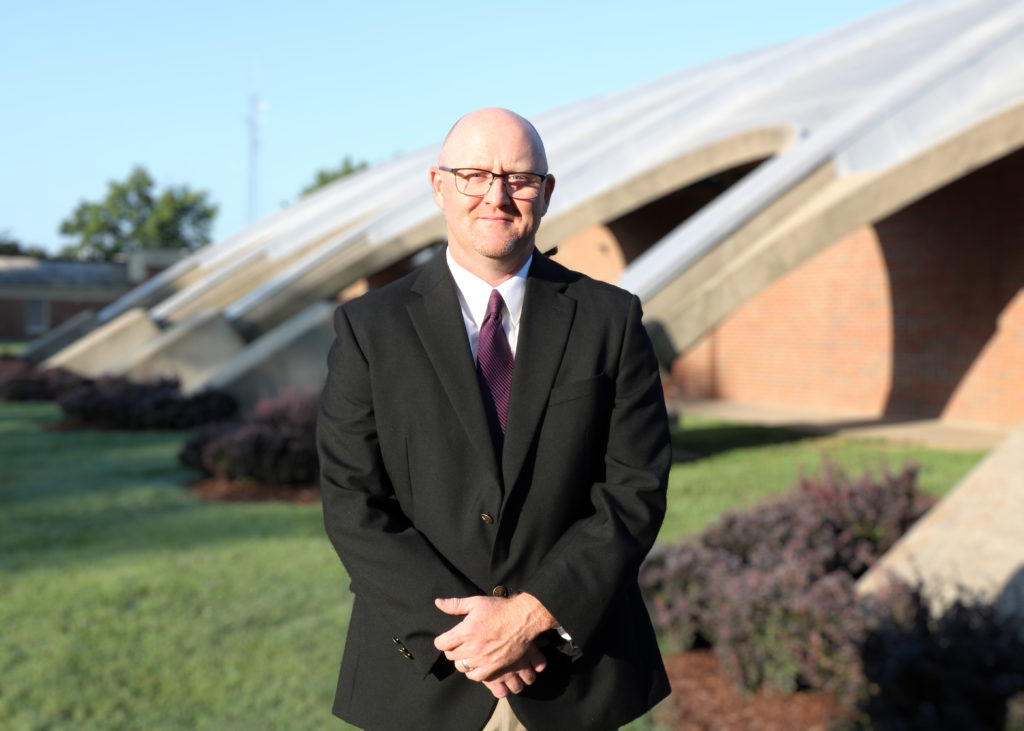 Brad Hill stands in front of the Bardstown High School gymnasium.