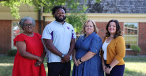 Family Resource and Youth Service Coordinators stand in front of the board of education. Left to Right is Sheila Calbert, Josh Payne, Katrina Haydon, and Catherine Jean Baptise.