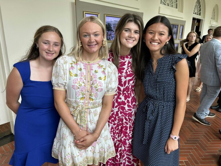 four female students standing in a line